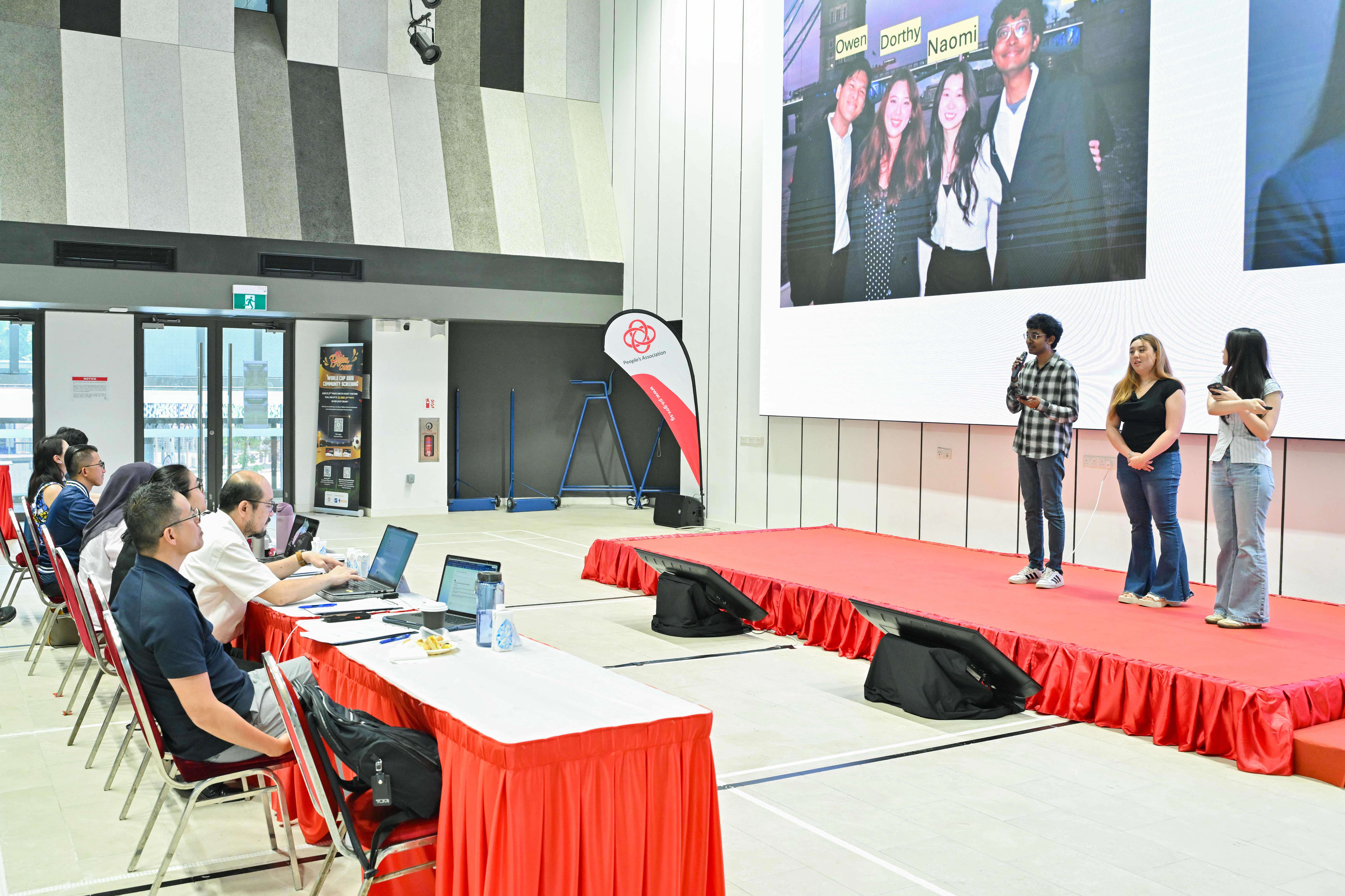 Three students giving a presentation in front of the panel
